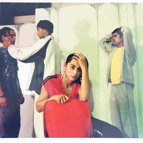 Photo of actors on stage during a performance of "Burning"