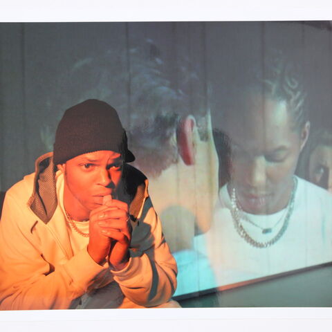 Photo of an actor on stage during a performance of "Burning"