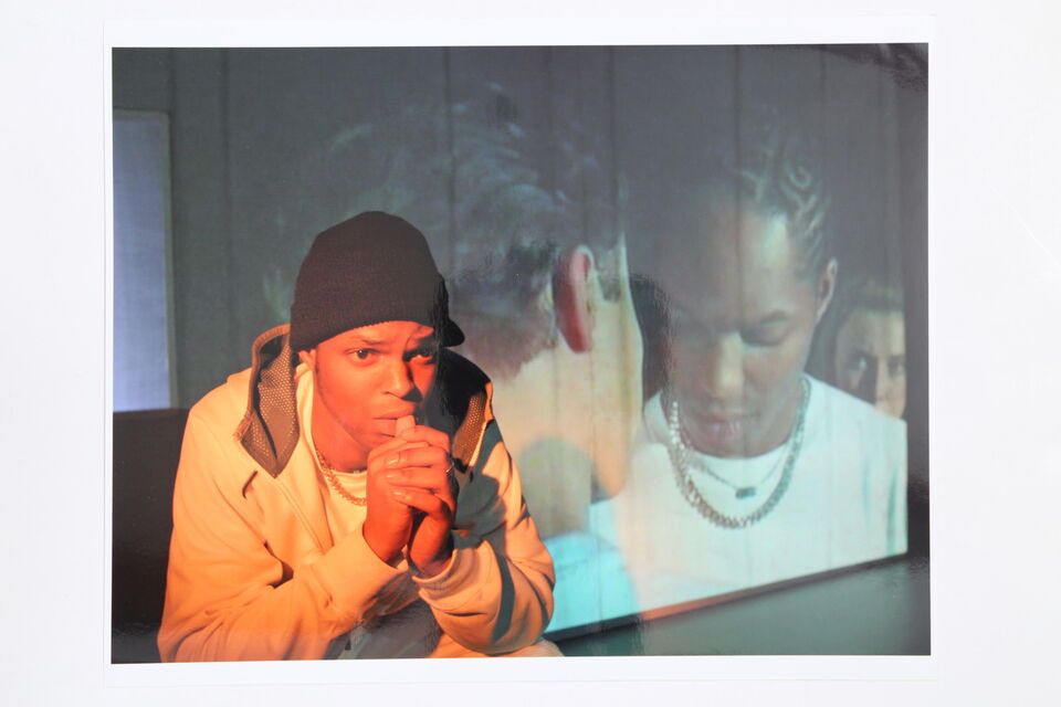 Photo of an actor on stage during a performance of "Burning"