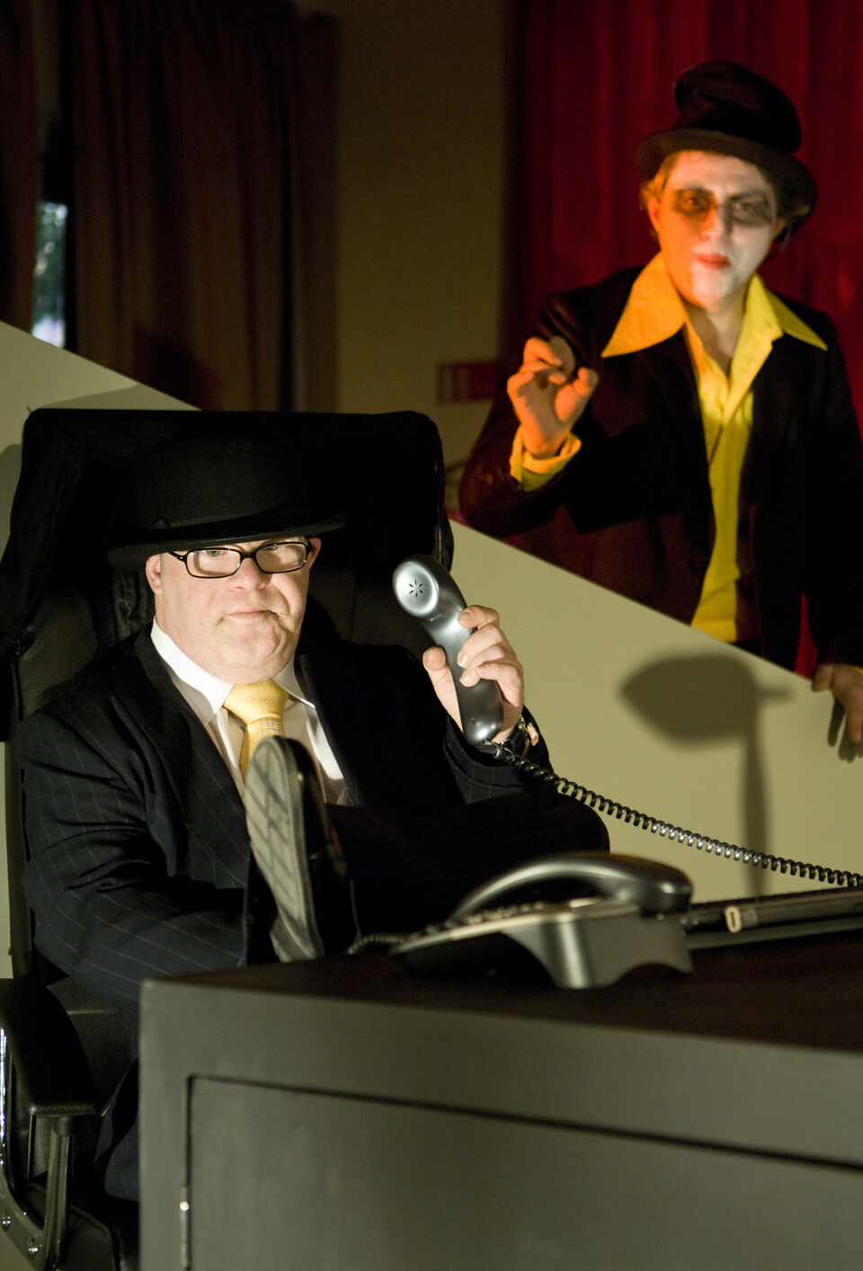 A photo of two actors during a performance of "Dark Inc"