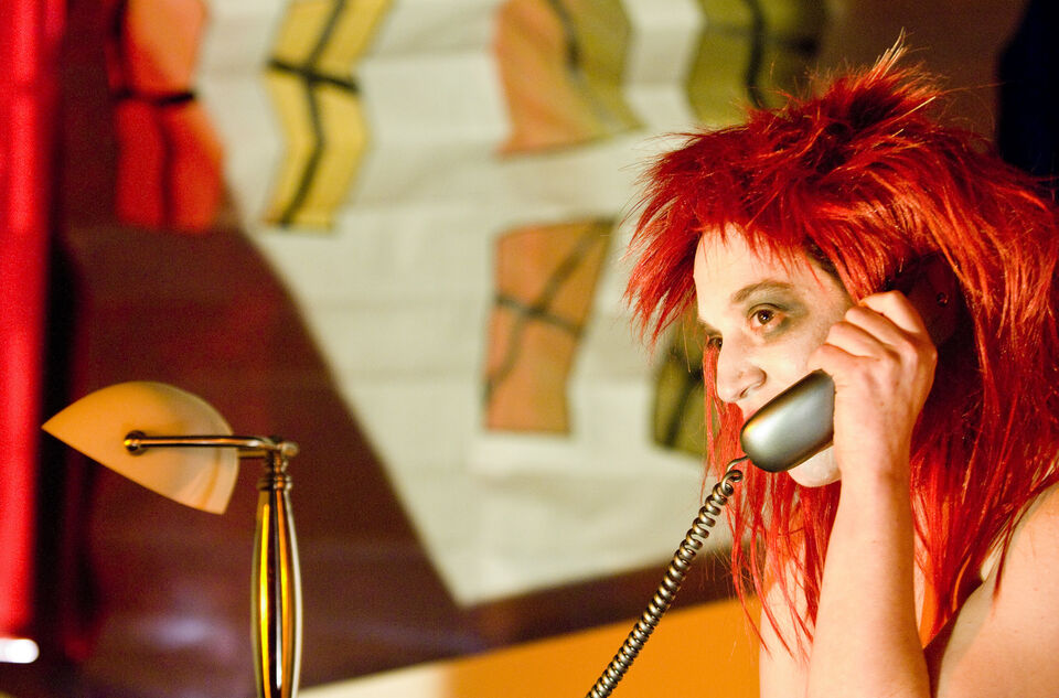 A photo of an actor during a performance of "Dark Inc"