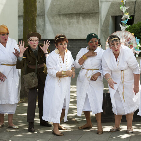 A photo of actors during a performance of "Trojan Women"