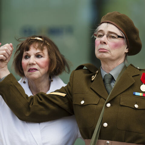 A photo of two actors during a performance of "Trojan Women"