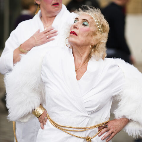 A photo of two actors during a performance of "Trojan Women"