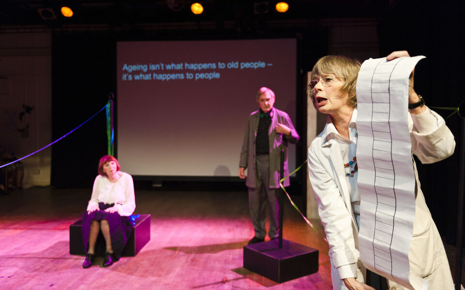 A photo of actors on stage during a performance of "Still Life Dreaming"