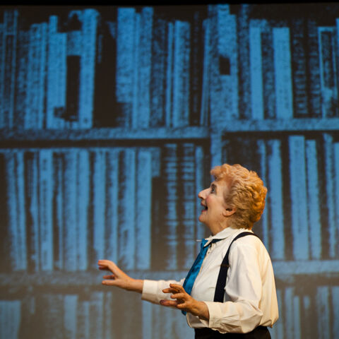 A photo of an actor on stage during a performance of "Still Life Dreaming"