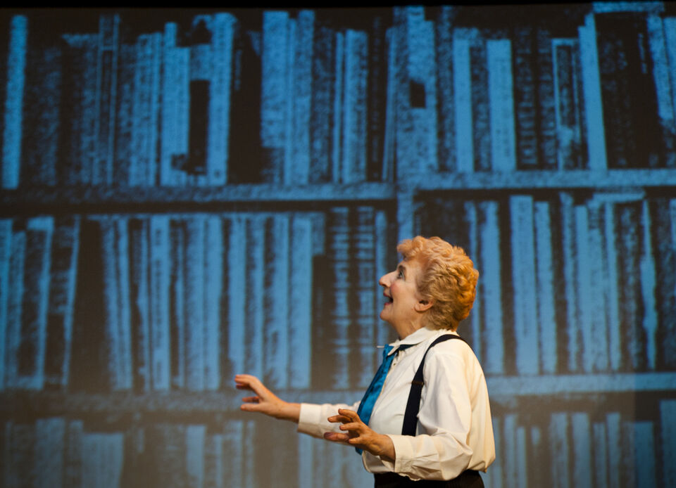 A photo of an actor on stage during a performance of "Still Life Dreaming"