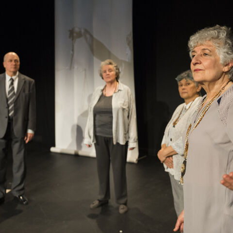 Actors on stage during a performance of "The Promise"
