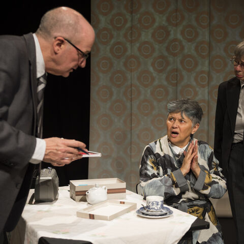 Actors on stage during a performance of "The Promise"