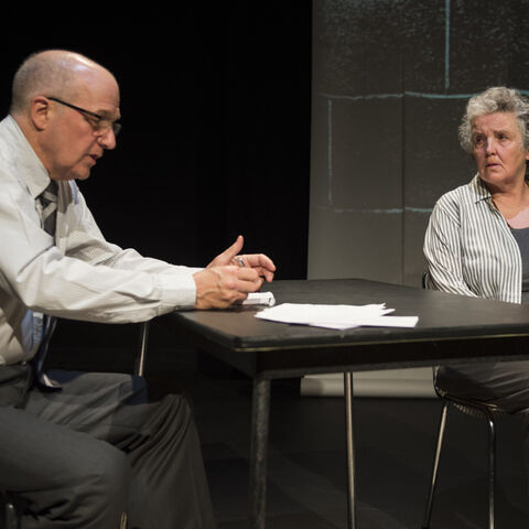 Actors on stage during a performance of "The Promise"