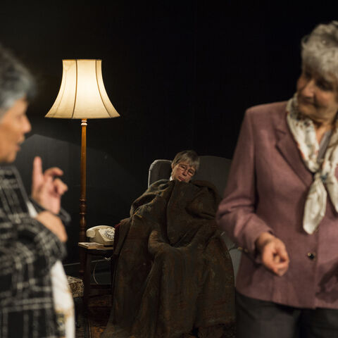 Actors on stage during a performance of "The Promise"