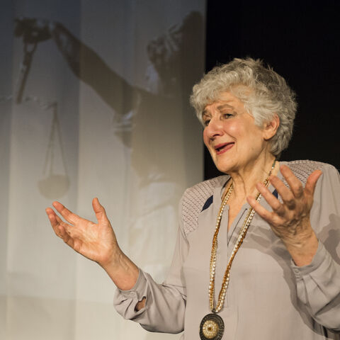 An actor on stage during a performance of "The Promise"