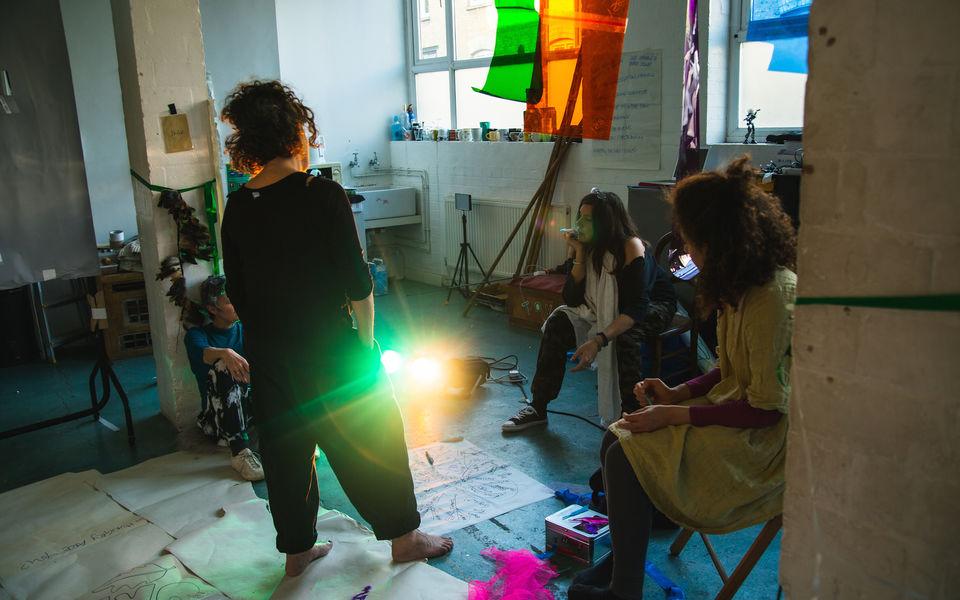 Three artist work in a rehearsal room