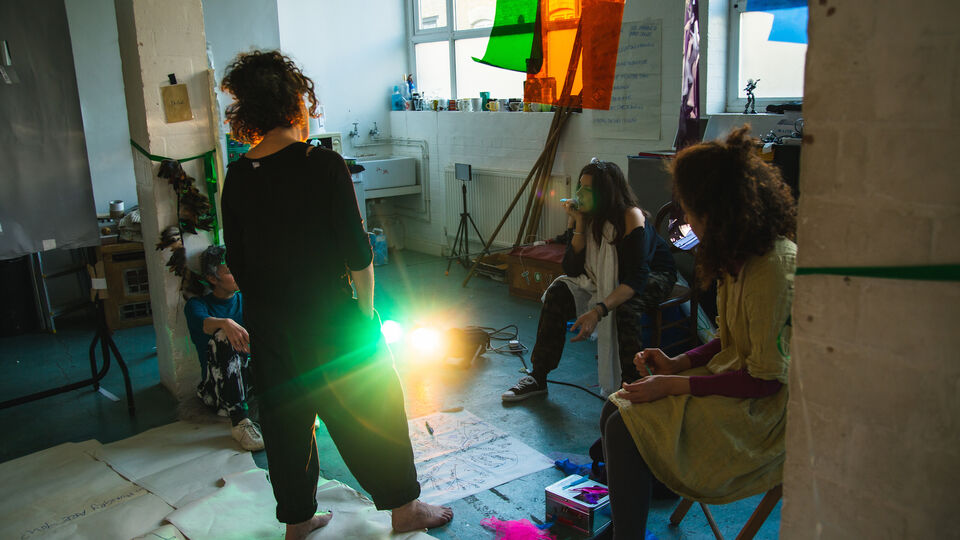 Three artist work in a rehearsal room