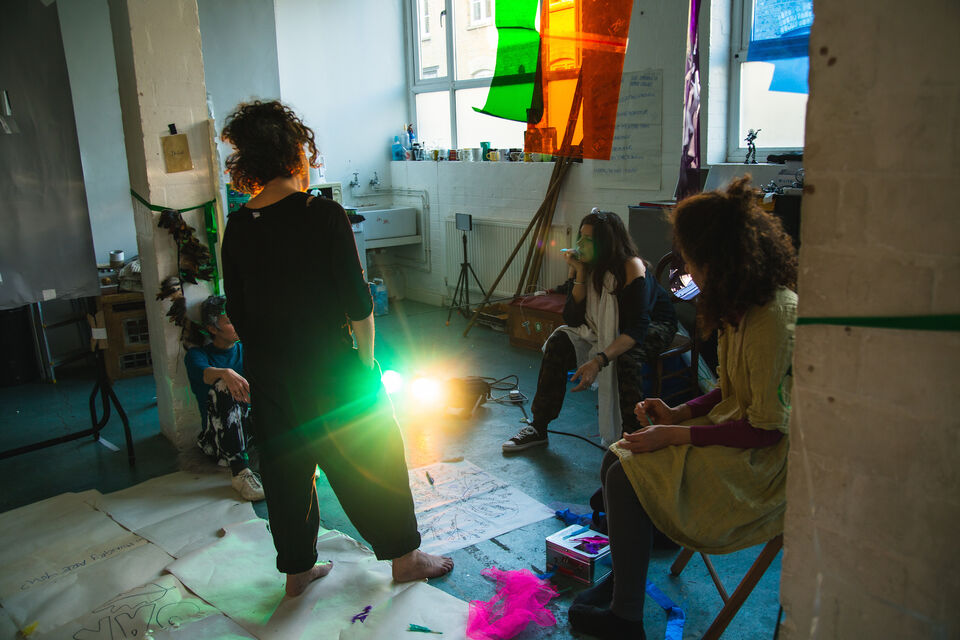 Three artist work in a rehearsal room